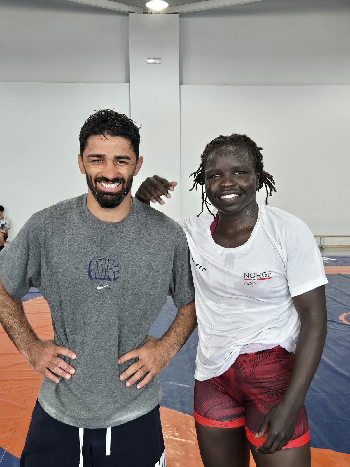 A coach and a visiting national-team wrestler on the mat in Tbilisi